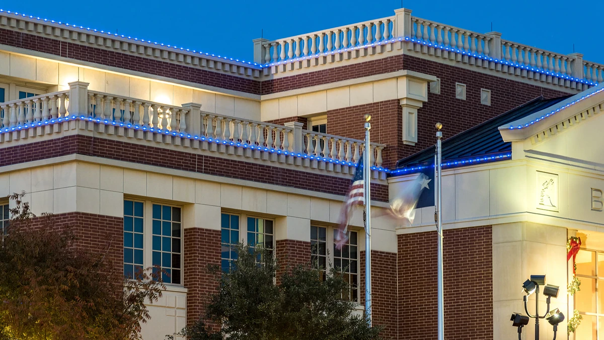 Blue permanent roofline lighting on a municipal building at dusk in Baltimore, MD by Optic Lighting